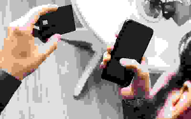 man inputting credit card information into cellphone
